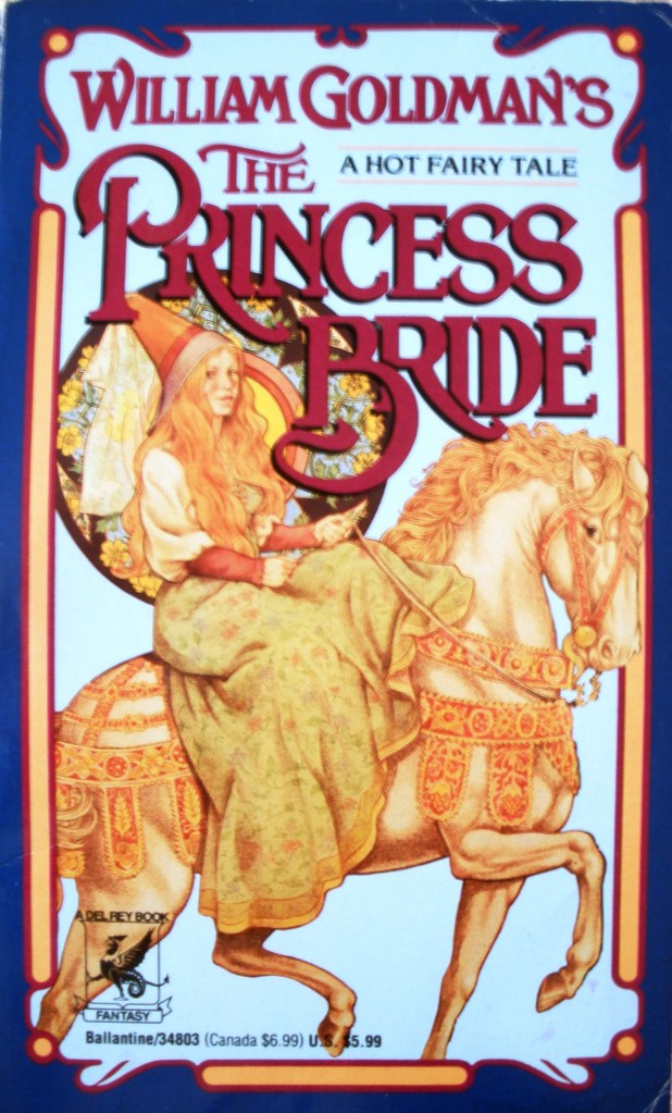 Book cover of the Princess Bride by William Goldman shows a woman on horseback, sidesaddle, dressed in medieval style, wearing a conical headdress with pendant veil
